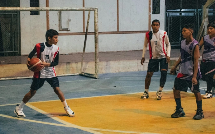 A group of young men playing a game of basketball